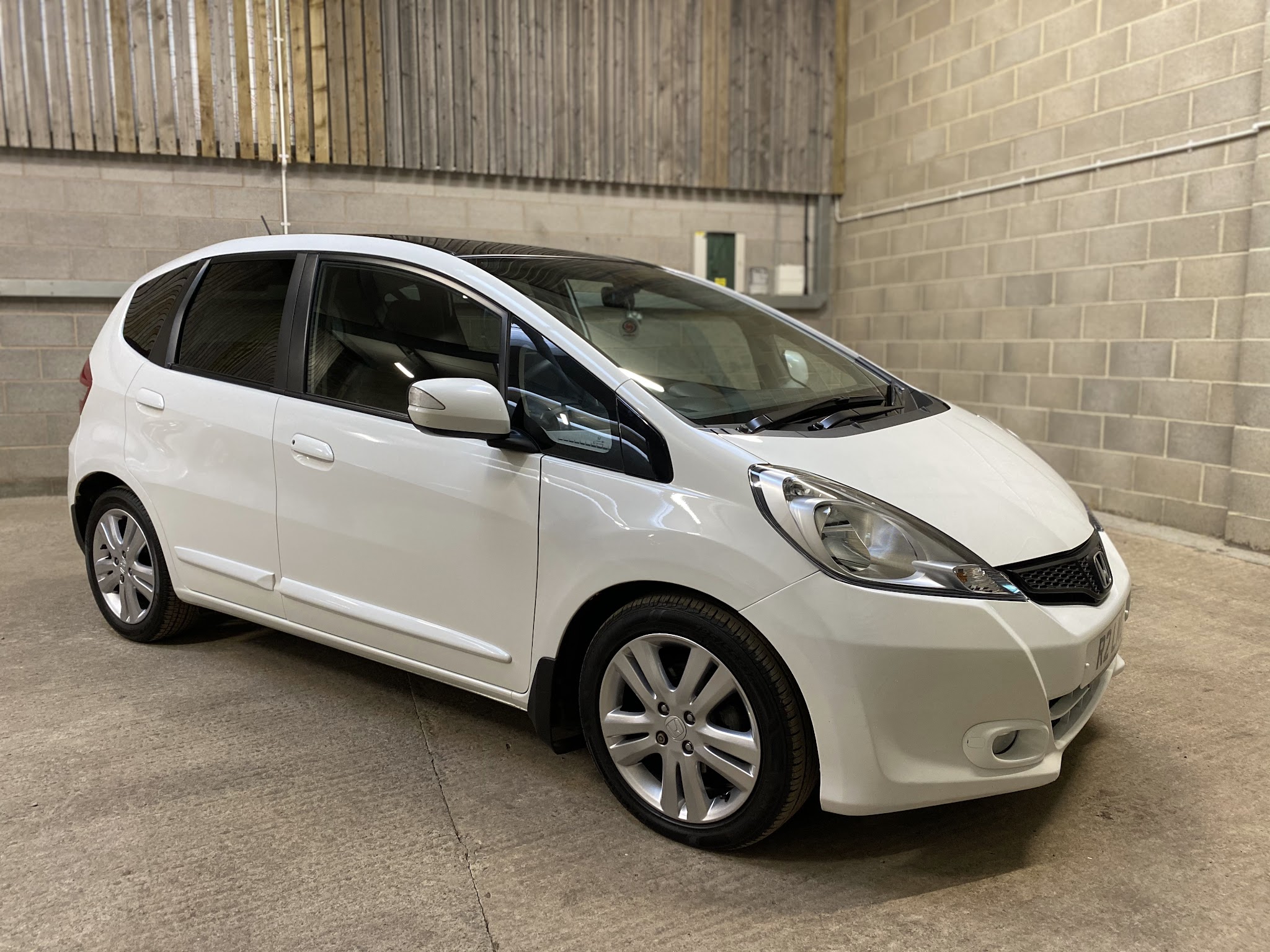 White Honda Jazz in the block-walled Thirsk Autocentre bay